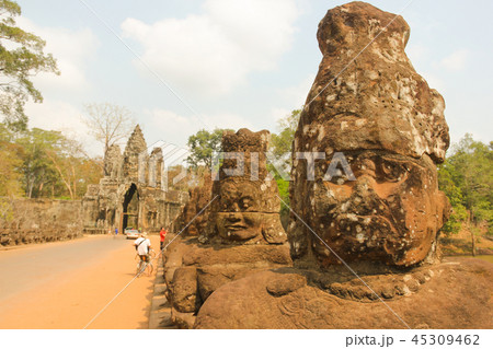 Faces statues on Angkor Wat temples bridge Faces statues on Angkor Wat temples bridge 45309462