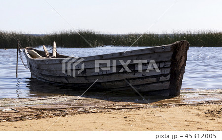 old wooden boat near the lake, used by local people for fishing