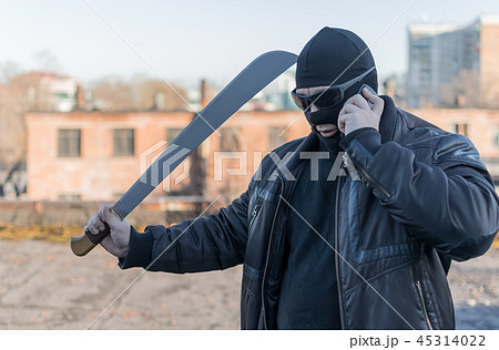 bandit with a machete in a black mask 45314022