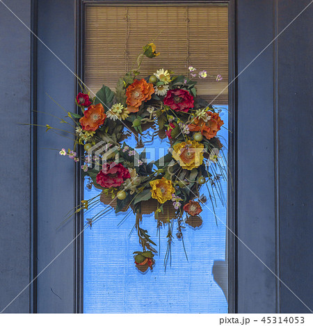 Decorative flower wreath hanging on a door 45314053