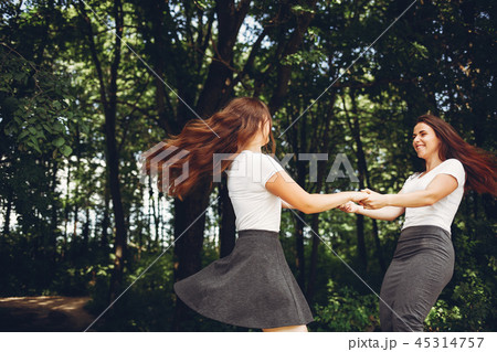 Cute sisters in a park 45314757
