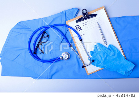 Medical stethoscope, gloves, RX prescription, and blue doctor uniform closeup. Medical help or Medical stethoscope, gloves, RX prescription, and blue doctor uniform closeup. Medical help or 45314782