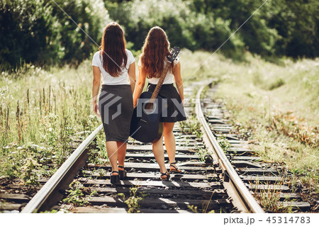 Cute sisters in a park Cute sisters in a park 45314783