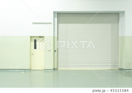 Shutter door and concrete floor inside factory bu Shutter door and concrete floor inside factory bu 45315384