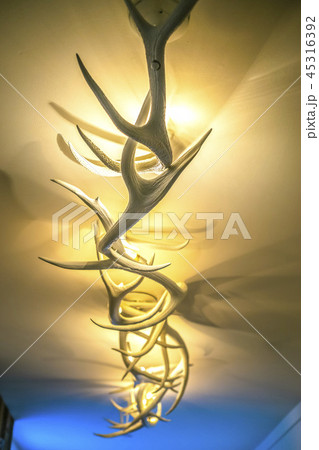 Antler deer light fixture in hotel lobby hallway Antler deer light fixture in hotel lobby hallway 45316392