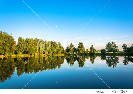 A small lake on a quiet summer evening. A small lake on a quiet summer evening. 45320681