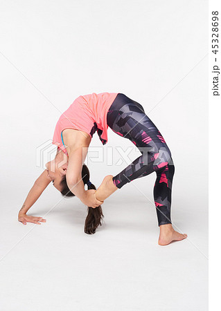 Woman practicing yoga Bridge pose on white Woman practicing yoga Bridge pose on white 45328698