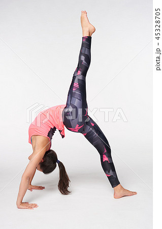 Woman practicing One-legged Bridge Pose over white 45328705