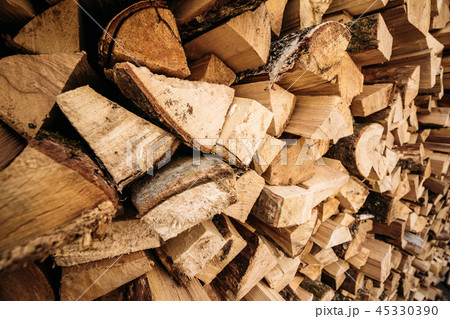 Wooden firewood stacked in a wall 45330390