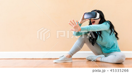 Young woman using a virtual reality headset Young woman using a virtual reality headset 45335266