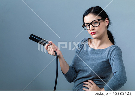 Young woman with an electric vehicle charger 45335422