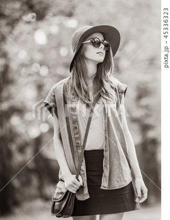 girl in sunglasses and hat in the autumn park. girl in sunglasses and hat in the autumn park. 45336323