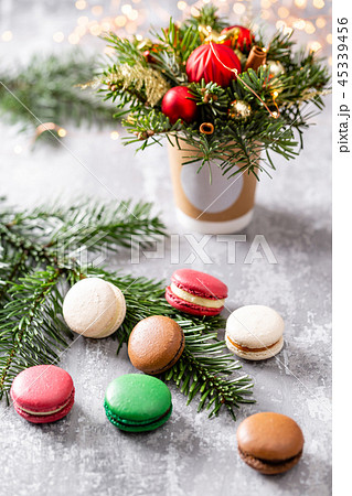 Variety of sweet macaroons. Fir branches on a gray background. Merry Christmas card. New year mood 45339456