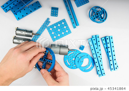 Man assembling metal robot kit 45341864