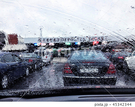Road view through car window with rain drops, Driving in rain 45342344