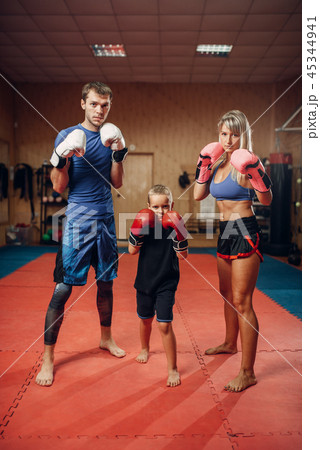 Young family in gloves on kickboxing training Young family in gloves on kickboxing training 45344941