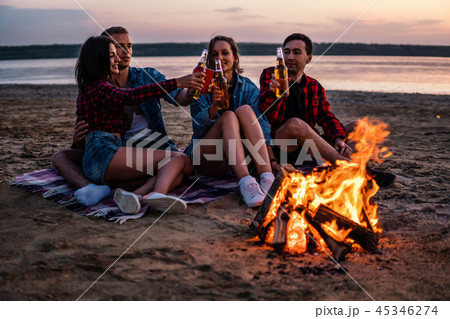 young friends have picnic with bonfire on the beach young friends have picnic with bonfire on the beach 45346274
