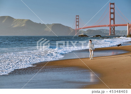 Woman walking on beach near Golden Gate Bridge 45348403