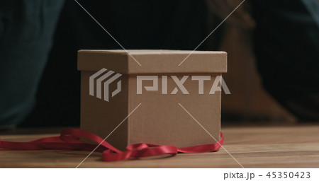 Closeup red ribbon and gift box 45350423