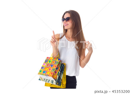 Woman in sunglasses with shopping bags Woman in sunglasses with shopping bags 45353200