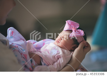cute baby sleep on hand's mom 45353306