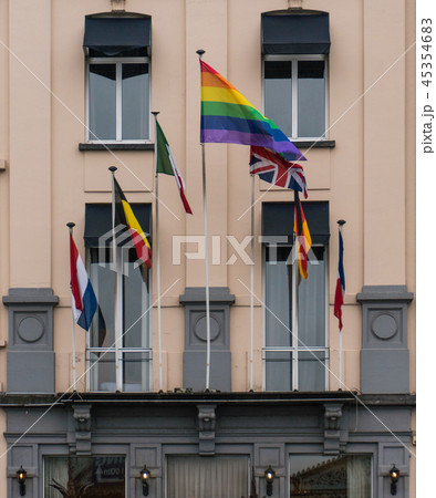 Gay rainbow flag accompanied with another european flags in the building facade Gay rainbow flag accompanied with another european flags in the building facade 45354683
