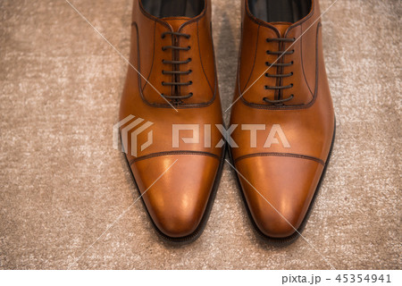 Brown leather classic male shoes on the floor Brown leather classic male shoes on the floor 45354941