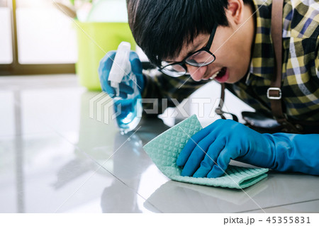 Husband housekeeping and cleaning concept, Happy young man in bl 45355831