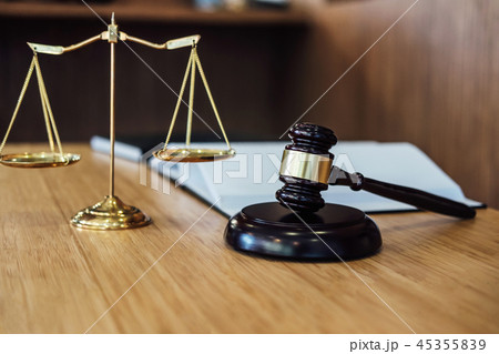 Scales of justice and Gavel on sounding block and law book to wo 45355839