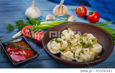 Dumplings in clay plate 45356381