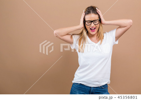 Young woman blocking her ears 45356801