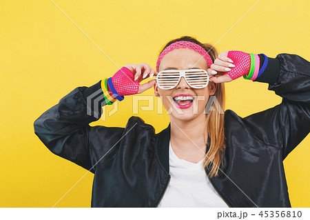 Woman in 1980's fashion with shatter shade glasses 45356810