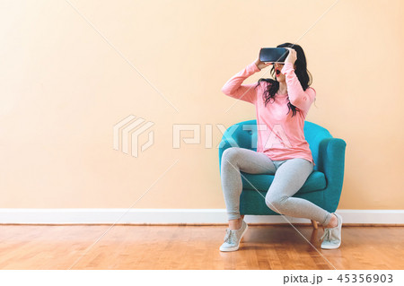 Young woman using a virtual reality headset Young woman using a virtual reality headset 45356903