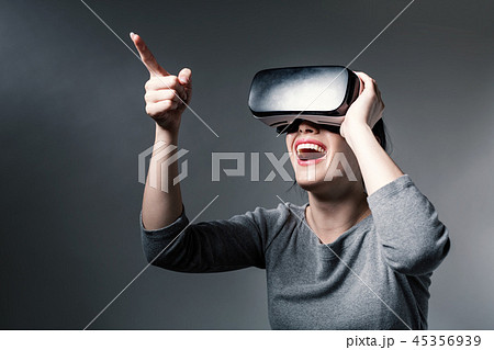Young woman using a virtual reality headset Young woman using a virtual reality headset 45356939