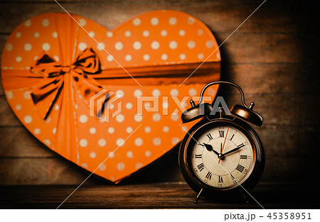 alarm clock on the table with heart shape gift 45358951