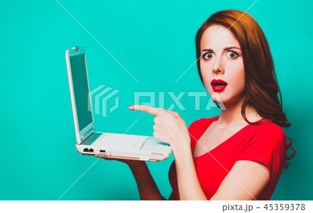 girl with laptop on blue background. girl with laptop on blue background. 45359378