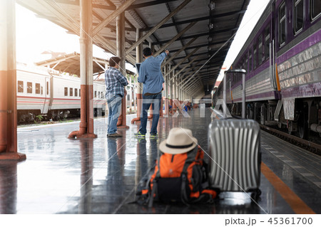 man with belongings waiting for travel by train. 45361700