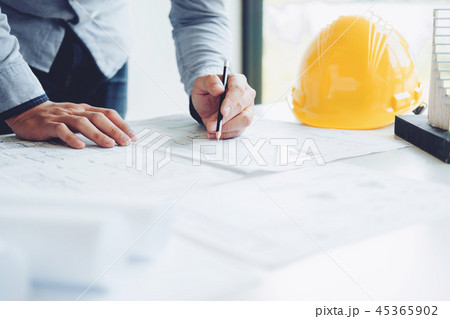 Architect or engineer working in office blueprint 45365902