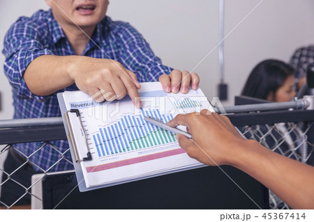 Manager holds financial report shows rising stats 45367414