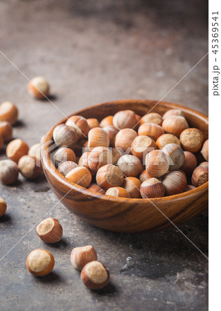 Natural hazelnut in a wooden bowl Natural hazelnut in a wooden bowl 45369541