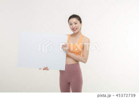 a woman holding an ad board on a white background a woman holding an ad board on a white background 45372739