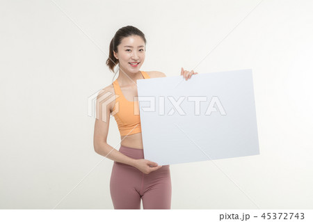 a woman holding an ad board on a white background a woman holding an ad board on a white background 45372743