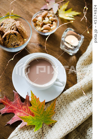A cup of hot cocoa with knitted blanket and snacks 45374924