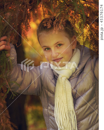 Happy girl laughing and playing in autumn leaves Happy girl laughing and playing in autumn leaves 45376174