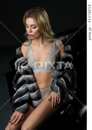 Slim blonde in underwear and fur-coat on the sofa Slim blonde in underwear and fur-coat on the sofa 45378058