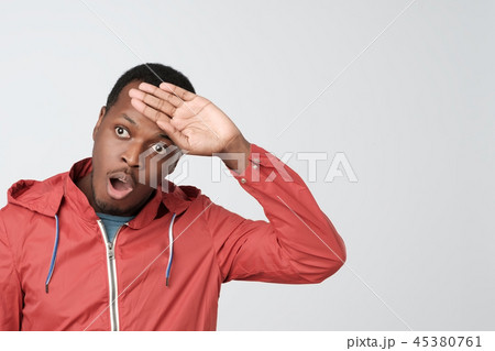 Man in red jacket, whiping sweat out of forehead. Man in red jacket, whiping sweat out of forehead. 45380761
