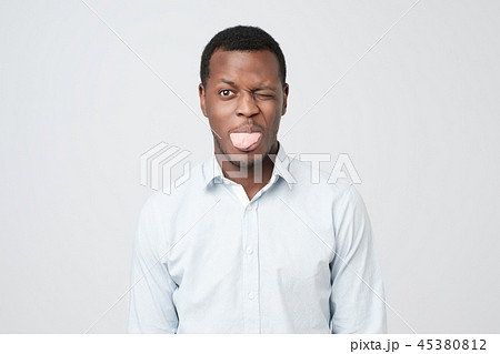 Young funny afro american man makes grimace Young funny afro american man makes grimace 45380812