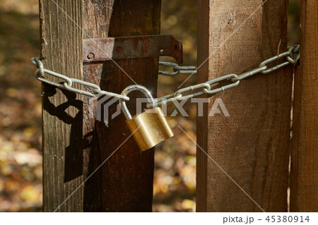 Old gate with padlock 45380914