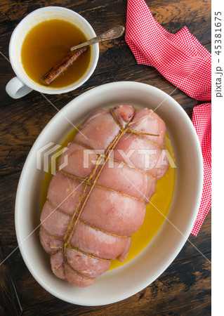 Raw stuffed turkey breast fillet and sauce 45381675