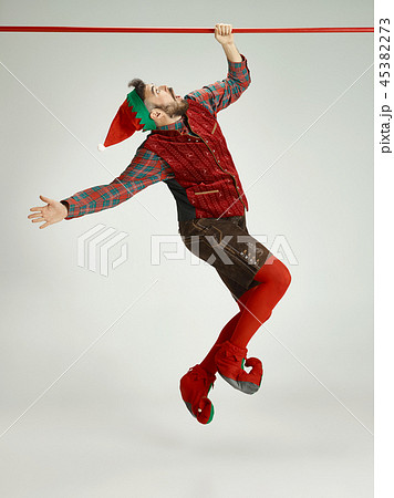 friendly man dressed like a funny gnome posing on an isolated gray background 45382273